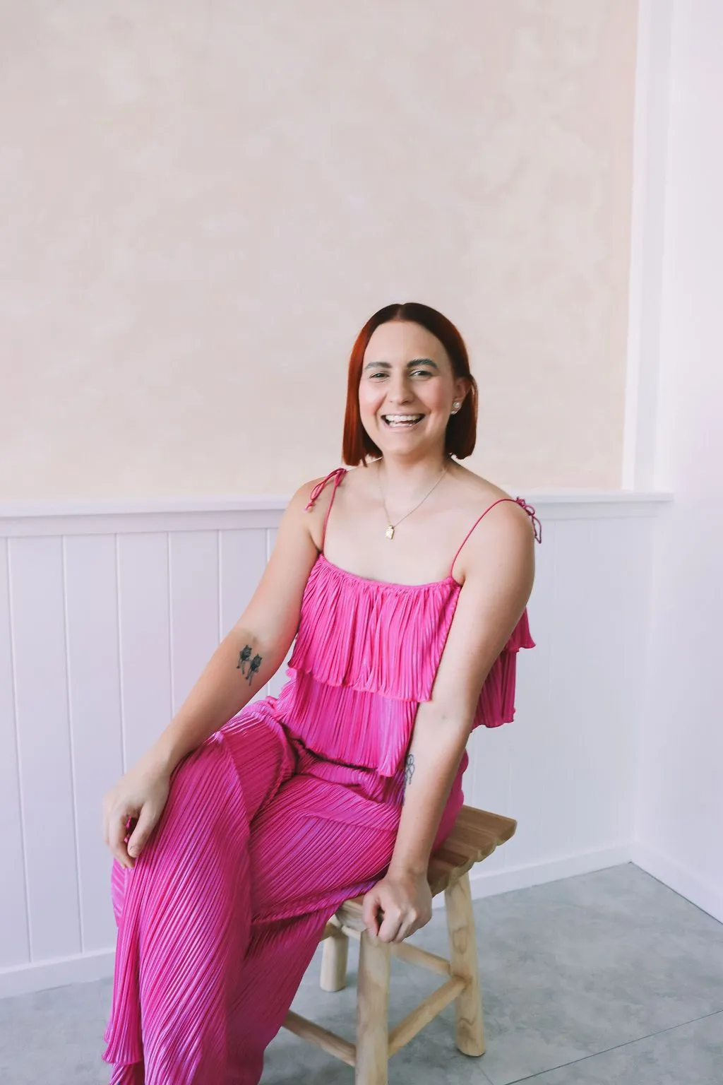 Katie smiling in a pink outfit